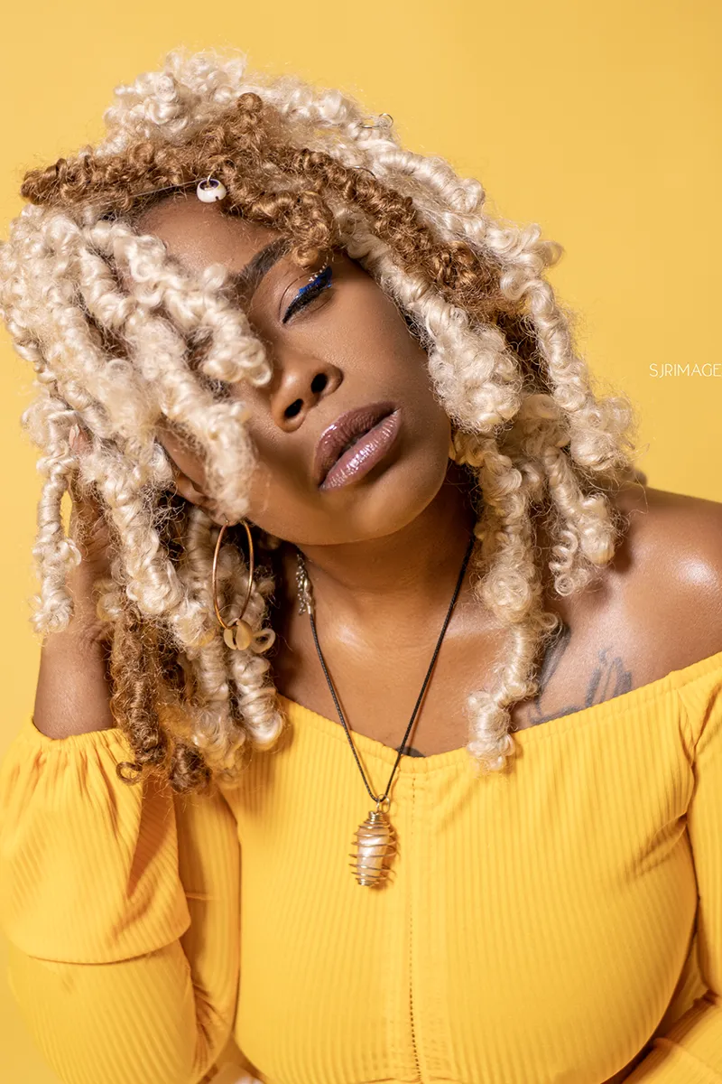 Creative headshot by SJRIMAGES – blonde locs with yellow backdrop