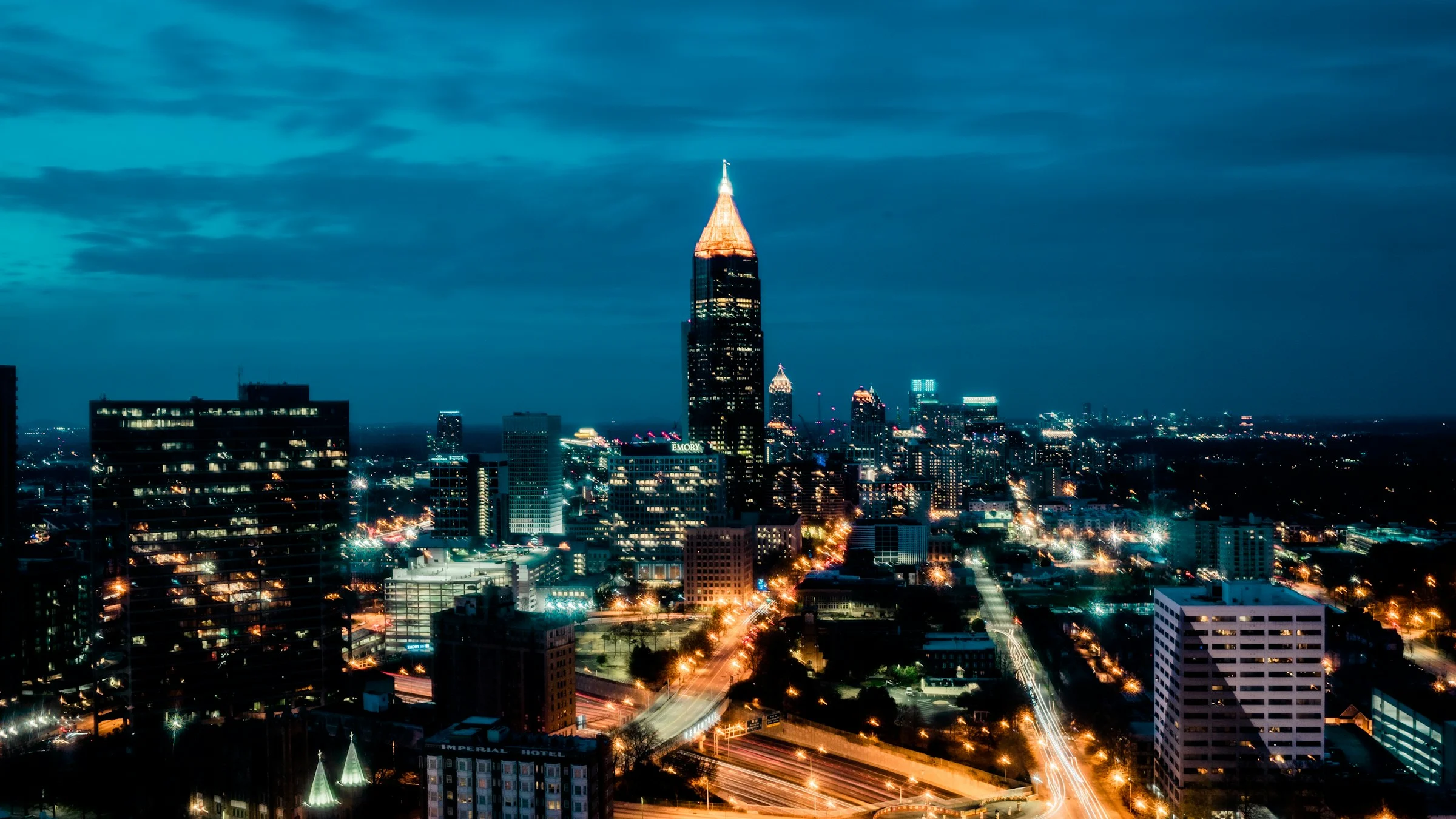 Aerial drone photography of Atlanta Georgia skyline at night with illuminated buildings and city lights